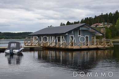 Проект деревянного дома из клееного бруса с крытой террасой расположенной по всему периметру дома Проект деревянного дома из клееного бруса с крытой террасой расположенной по всему периметру дома